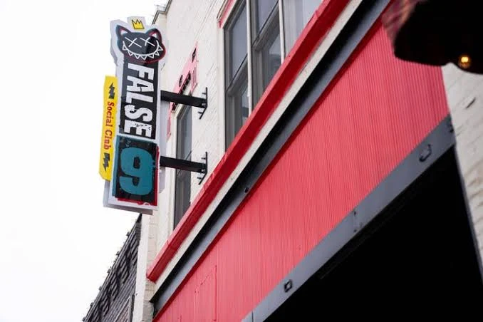 False 9’s crowned-cat sign above the red 5th Street storefront